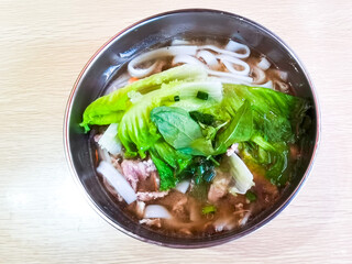 Pork soup rice noodles in stainless steel bowl