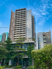 Obraz premium A low angle view of office building skyscraper inside a corporate park in downtown Guangzhou, China.
