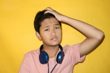 A teenager is holding their head, indicating they forgot something.