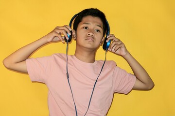 A boy is about to put on his headphones.