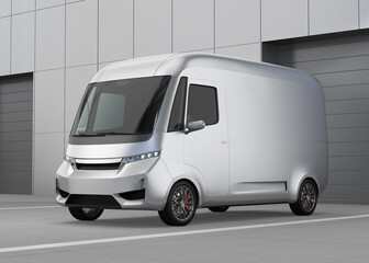 Metallic silver Electric Delivery Van parking in front of a warehouse buidling. Generic design. 3D rendering image.