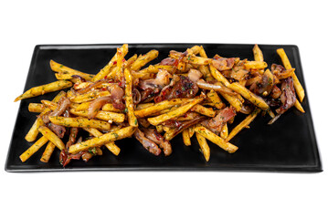 Fried french fries with pork meat on black plate isolated on white background