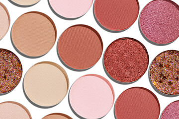 Eyeshadow palette, mix of matte and shimmer shades in pink, nude, red, brown hues. Minimal top view pattern for beauty, makeup, cosmetics themes, Vivid colored swatches eyeshade refills circle shape