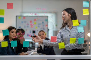 A woman is giving a presentation to a group of people