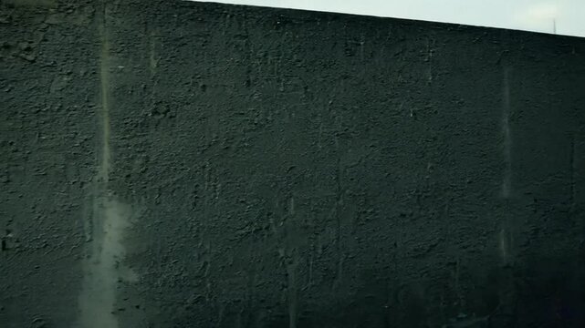 Black dark concrete wall video. Board cement texture grunge dirty scratched for show anthracite promote product urban floor. close up. 4K
