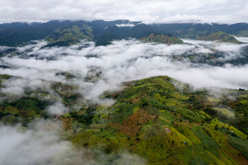Landscape of Morning Mist with Mountain Layer at north of Thailand. mountain ridge and clouds in rural jungle bush forest