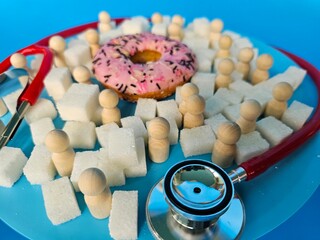 People patients in medical theme with donut, sugar cubes and wooden figures.