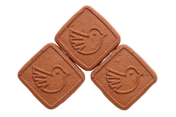 Three brown biscuits with a painted bird isolated on a white background.