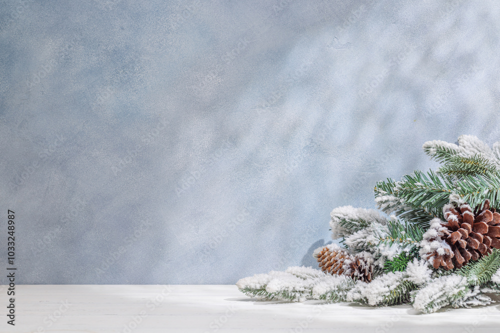 Aufkleber christmas template featuring snowy fir tree branches on a table with shadows and sun glares softly f