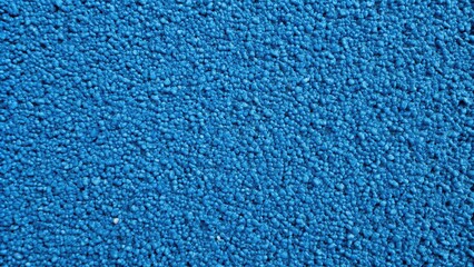 Blue abstract background made of porous recycled rubber tile with leading lines