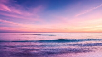 Fototapeta premium A serene sunset over calm ocean waters, with pastel colors reflecting on the waves, creating a peaceful and picturesque coastal scene.