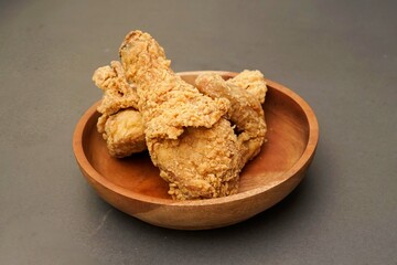 Fried Chicken breast hot crispy strips crunchy chicken tenders three pieces isolated on black background. Crispy fried chicken is a food made from fried chicken placed on a plate.