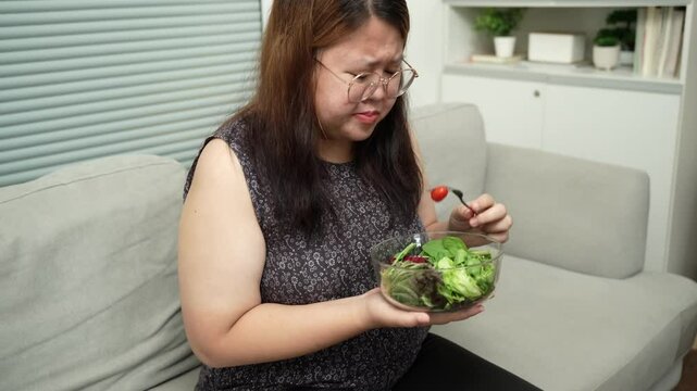 Asian Overweight woman dieting Weight loss eating fresh fresh homemade salad healthy eating concept Obese Woman with weight diet lifestyle.