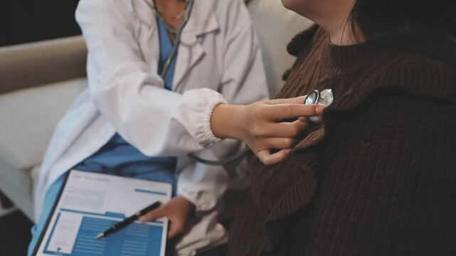 Doctor use stethoscope, checking up heart beat, lunch of auscultation in doctor office at hospital. Patient worker has to get medical checkup every year for her health or medical checkup cardiologist