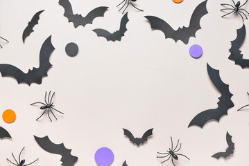 Frame made of paper bats and spiders for Halloween party on grey background