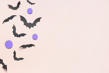 Paper bats for Halloween party on pink background