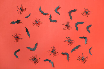 Frame made of paper bats and spiders for Halloween party on red background