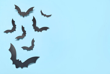 Paper bats for Halloween party on blue background