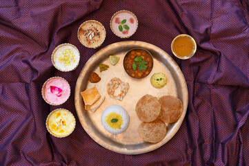 Maharashtrian thali made on the occasion of Gudi Padwa which includes 5 flavoured homemade Shrikhand, Puri, Chhole, Dal, Rice, Papad, Aam Panna etc.