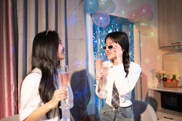 Two happy young girls laughing, drinking, sharing pizza at home party late, Friendship leisure rest home enjoy concept, sweet moment of childhood, family, celebration, friendship and home life.