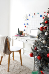 Workplace with blank laptop and Christmas decor in office