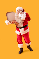 Santa Claus with tasty pizza on yellow background