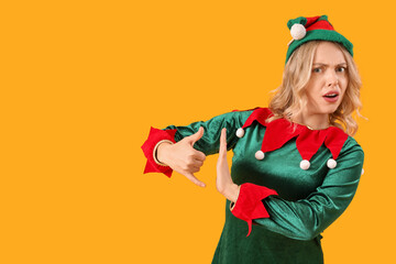Displeased young woman dressed as elf showing 