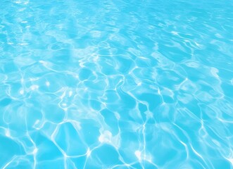 Fototapeta premium Clear blue water surface with sunlight reflections creating ripple patterns. Summer and relaxation concept. Design for wallpaper, banner, and background