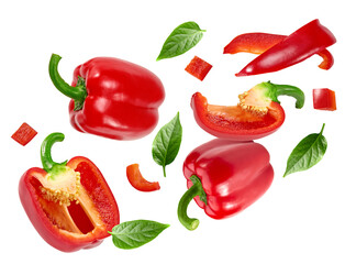 flying sliced red sweet bell pepper with green leaves isolated on white background. clipping path