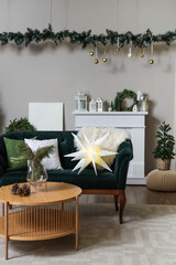 Interior of festive living room with green sofa, wooden coffee table and Christmas decorations