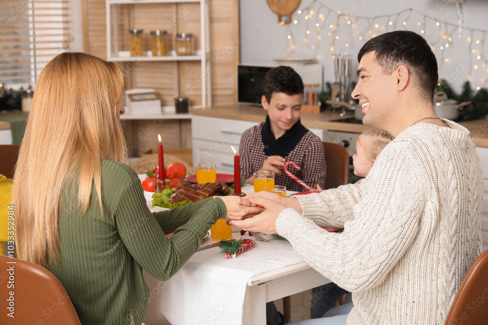 Sticker Young couple having family dinner at home on Christmas eve, back view