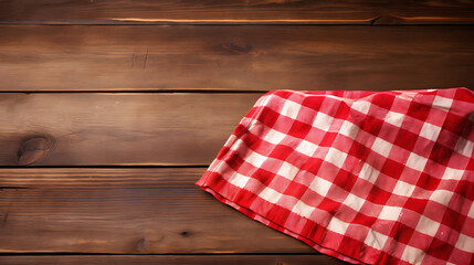 Obraz premium Red checkered kitchen cloth on wooden table evokes cozy atmosphere