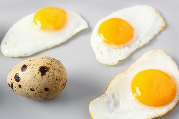 Fried quail eggs on grey background