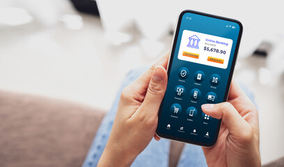 Woman using smartphone to conduct online mobile banking. Business and technology concept