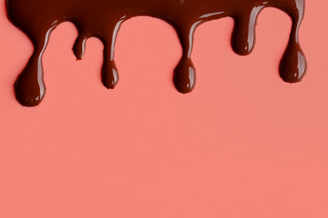 Sweet chocolate splash on red background