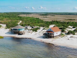 Holiday homes on stilts on sandunes at the waters edge on Cedar Island, North Carolina, United States.