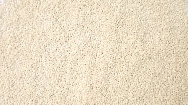 Sago pearls or tapioca pearls rotating full frame background, top view looped spinning, close up, herbs and spices