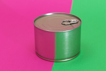 Tin Can on Split Green and Cyan Background. Canned Food. Aluminum Can for Safe and Long Term Storage of Food. Steel Sealed Food Storage Container