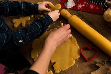 Making Christmas cookies with cookie molds and preparing them for baking, close up