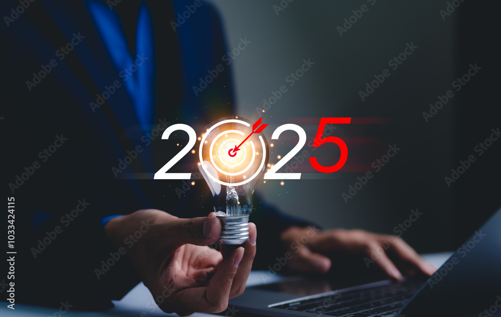 Wall mural 2025 business goals and strategy planning concept. businessman holds lightbulb with a target symbol 