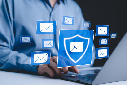 Email security and protection technology concept. A person uses laptop with virtual email protection icon. symbolizing secure communication, data privacy, cybersecurity in email systems. spam virus,