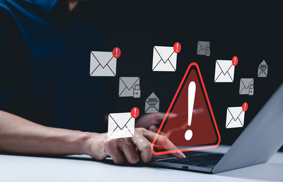 Email security warning notification concept. A person using laptop with email security alert icons and warning notifications, indicating cybersecurity threats such as spam, viruses, junk mail, scams,