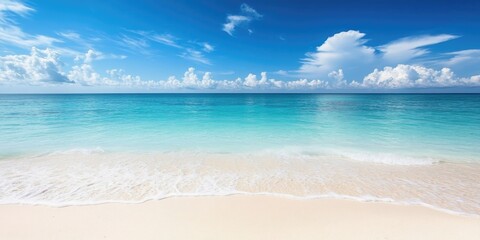 Fototapeta premium White sandy beach, clear blue ocean, visible horizon, beautiful sky with clouds.