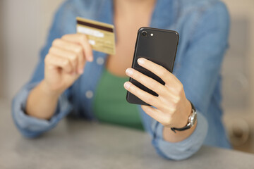 woman using credit card and with smartphone