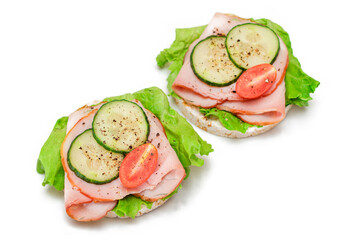 Light Breakfast. Quick and Healthy Sandwich. Rice Cake with Ham, Tomato, Fresh Cucumber and Green Salad - Isolated on White