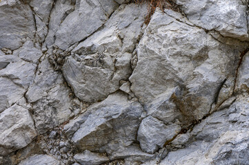 Close-up of rugged gray rock formations displaying intricate textures and patterns in a natural outdoor setting under diffused lighting