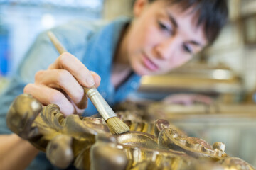 portrait of woman refurbishing furniture