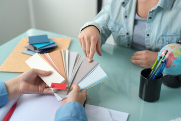 hands choosing a color from the sampler