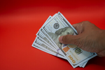 Capture the essence of wealth and success with this striking image of a hand confidently grasping a...