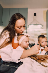 A mother and her children cook together in the kitchen, highlighting how cooking helps develop essential skills in kids.